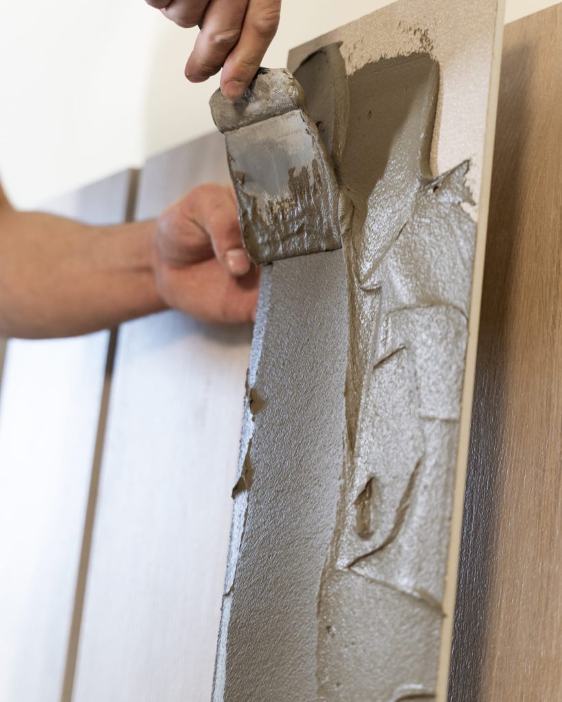 close-up-hands-using-tools-tiles